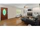 Stylish living room featuring hardwood floors and a decorative brick fireplace at 524 Preston Andrews Rd, Bahama, NC 27503