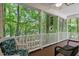 Relaxing screened porch with comfortable seating surrounded by lush greenery and a tranquil atmosphere at 524 Preston Andrews Rd, Bahama, NC 27503
