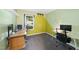 Bright bedroom with neutral carpet, natural light from the window and two workspaces at 5300 Whippoorwill St, Durham, NC 27704