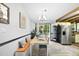 Bright dining area featuring a built-in bench, modern lighting, and seamless access to the kitchen at 5300 Whippoorwill St, Durham, NC 27704