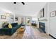 Comfortable living room with a fireplace, a cozy sofa, and large windows providing ample natural light at 5300 Whippoorwill St, Durham, NC 27704