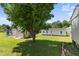 A shed, a back door, privacy fence, and mature trees adorn this green backyard at 55 Ayden Dr, Clayton, NC 27520