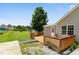 A back deck, a well-maintained lawn, a privacy fence, and mature trees adorn this backyard at 55 Ayden Dr, Clayton, NC 27520