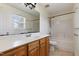 Bathroom featuring a single sink vanity with wood cabinets, and a shower and tub at 55 Ayden Dr, Clayton, NC 27520