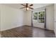 Bright bedroom with wood-look flooring, ceiling fan, and natural light from a large window at 55 Ayden Dr, Clayton, NC 27520
