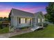 Charming one-story home features a ramp, manicured lawn, and beautiful twilight sky at 55 Ayden Dr, Clayton, NC 27520