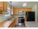 Bright kitchen boasts stainless steel appliances, light cabinets, and a functional layout at 55 Ayden Dr, Clayton, NC 27520