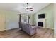 Cozy living room features a fireplace, ceiling fan and updated flooring at 55 Ayden Dr, Clayton, NC 27520