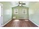 Bright room with two windows, a ceiling fan, and vinyl flooring at 55 Ayden Dr, Clayton, NC 27520