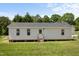 The backyard features an outbuilding or mother-in-law suite with multiple windows and a back door at 55 Ayden Dr, Clayton, NC 27520