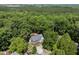 Aerial view reveals the home nestled in a forest, featuring a wooden deck at 556 Margaret Pl, Garner, NC 27529