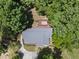 Home with a well-maintained roof and wooden deck surrounded by a dense, green forest at 556 Margaret Pl, Garner, NC 27529