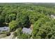 Overhead view of the home, surrounded by lush trees, featuring a spacious driveway at 556 Margaret Pl, Garner, NC 27529
