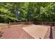 Spacious wooden deck perfect for outdoor dining and entertaining, surrounded by trees at 556 Margaret Pl, Garner, NC 27529