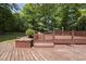 Spacious wooden deck perfect for outdoor dining and entertaining, surrounded by trees at 556 Margaret Pl, Garner, NC 27529