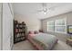 Cozy bedroom with natural light, a ceiling fan, and a bookcase filled with books at 556 Margaret Pl, Garner, NC 27529