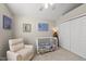 Cozy bedroom features vaulted ceiling, a window, a crib, and soft chair at 556 Margaret Pl, Garner, NC 27529