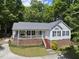 Charming home featuring a brick foundation, cozy porch, and well-maintained landscaping at 556 Margaret Pl, Garner, NC 27529