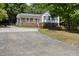 Charming exterior view of a home with a welcoming front porch and a well-maintained yard at 556 Margaret Pl, Garner, NC 27529