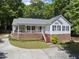 Inviting home with a welcoming front porch, complemented by a charming brick foundation at 556 Margaret Pl, Garner, NC 27529