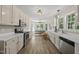 Bright, spacious kitchen features stainless steel appliances, white cabinets, and a dining area with natural light at 556 Margaret Pl, Garner, NC 27529
