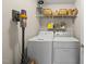Functional laundry room with washer, dryer, storage shelves and a vacuum cleaner at 556 Margaret Pl, Garner, NC 27529