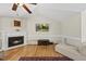 Inviting living room boasts a fireplace, ceiling fan, and comfortable seating at 556 Margaret Pl, Garner, NC 27529