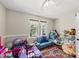 Bright playroom with hardwood floors, ceiling fan, sofa, large window and toys at 556 Margaret Pl, Garner, NC 27529