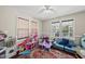 Bright playroom with hardwood floors, ceiling fan, sofa, large window and toys at 556 Margaret Pl, Garner, NC 27529