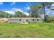 Backyard patio and exterior view of the white-painted home on a large lot at 5718 Woodcrest Dr, Raleigh, NC 27603
