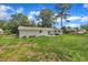 Outdoor patio and exterior view of the white-painted home on a large lot at 5718 Woodcrest Dr, Raleigh, NC 27603