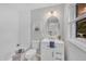 Bright bathroom with a white vanity, neutral walls, and chrome fixtures at 5718 Woodcrest Dr, Raleigh, NC 27603