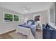 Inviting bedroom featuring natural light, a ceiling fan, vinyl floors and neutral wall paint at 5718 Woodcrest Dr, Raleigh, NC 27603