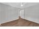Empty bedroom with neutral colors, wood floors, ceiling fan and light fixture at 5718 Woodcrest Dr, Raleigh, NC 27603