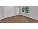 Neutral bedroom featuring wood floors, a closet, and a window to the outside at 5718 Woodcrest Dr, Raleigh, NC 27603