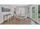 Open dining area featuring modern furnishings, vinyl plank flooring, and easy access to the outdoor space at 5718 Woodcrest Dr, Raleigh, NC 27603