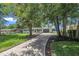 Attractive home featuring a long driveway and a well-maintained front lawn with mature trees at 5718 Woodcrest Dr, Raleigh, NC 27603