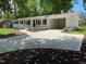 Beautifully renovated brick ranch with a new driveway, landscaping, and covered entryway at 5718 Woodcrest Dr, Raleigh, NC 27603