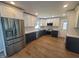 Renovated kitchen with stainless steel appliances, two-tone cabinets, backsplash, and wood-look flooring at 5718 Woodcrest Dr, Raleigh, NC 27603