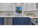 Modern kitchen featuring stainless steel appliances, white cabinets, and gray subway tile backsplash at 5718 Woodcrest Dr, Raleigh, NC 27603