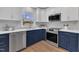 Stylish kitchen featuring updated appliances, designer cabinets, and hardwood floors at 5718 Woodcrest Dr, Raleigh, NC 27603