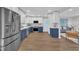 Modern kitchen featuring stainless steel appliances, white cabinets, and hardwood floors at 5718 Woodcrest Dr, Raleigh, NC 27603