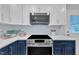 Well-lit kitchen showcasing modern appliances, cabinetry, and light gray subway tile backsplash at 5718 Woodcrest Dr, Raleigh, NC 27603