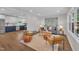 Open-concept living room, with hardwood floors, comfortable furniture, and blue and white cabinets at 5718 Woodcrest Dr, Raleigh, NC 27603