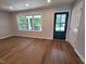 Bright living room featuring fresh paint, new floors, updated trim, and a large front window at 5718 Woodcrest Dr, Raleigh, NC 27603