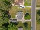 Aerial view of a home with mature trees, spacious yard, detached garages, and ample parking on paved driveway at 609 Chivalry Dr, Durham, NC 27703