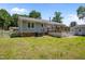 Rear of home featuring deck and a large lawn, perfect for relaxing and entertaining at 609 Chivalry Dr, Durham, NC 27703
