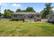 Back exterior view with a wooden deck and a spacious yard, great for outdoor gatherings at 609 Chivalry Dr, Durham, NC 27703