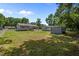 Expansive backyard featuring a deck, outbuildings, and ample green space for recreation at 609 Chivalry Dr, Durham, NC 27703