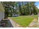 Large, well-maintained backyard with a storage shed and mature trees, ideal for outdoor activities at 609 Chivalry Dr, Durham, NC 27703